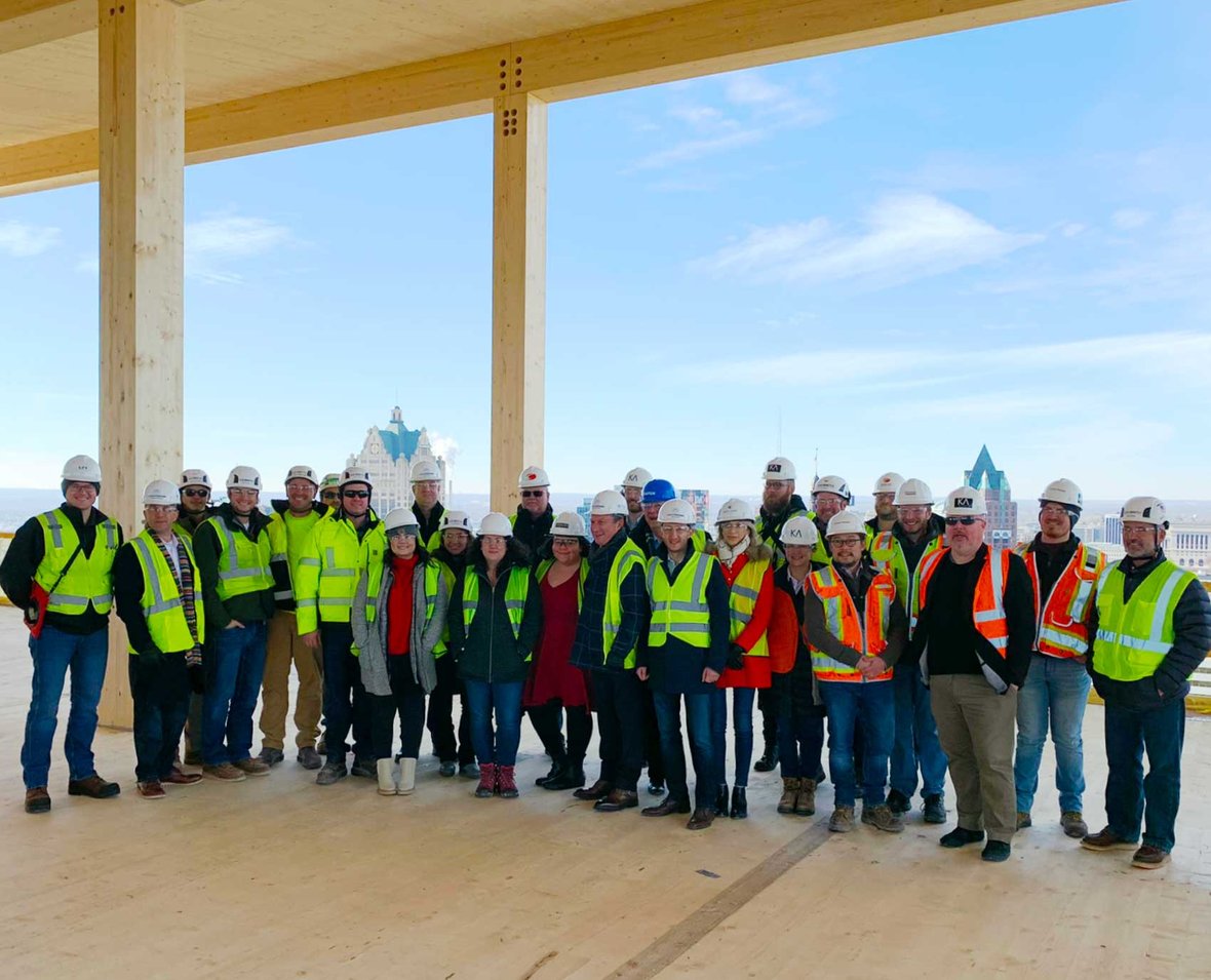 Stakeholders group photo on 25th floor to celebrate topping off Ascent mass timber tower as world's tallest with C.D. Smith Construction