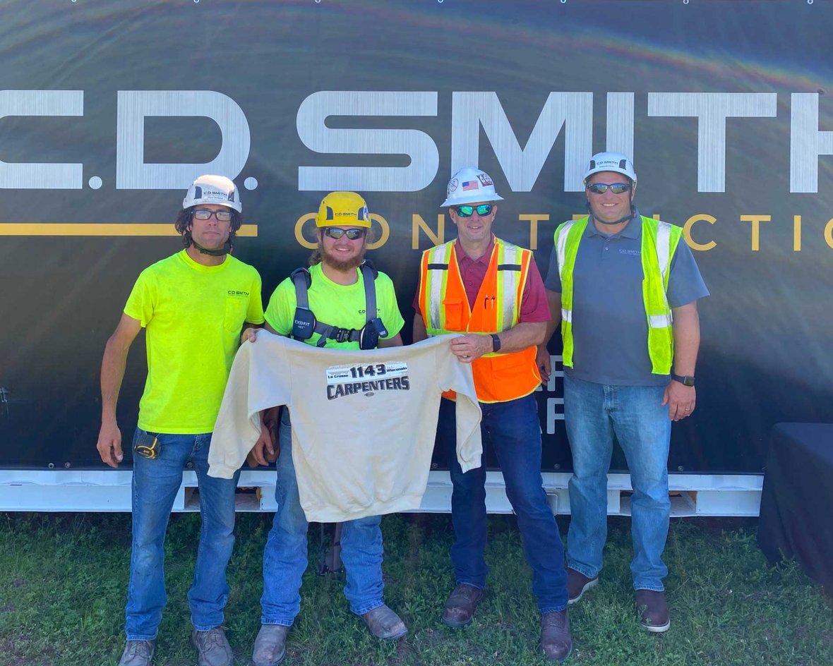 Signing day picture with Jaden Schindler being hired by C.D. Smith Construction while pursuing a carpentry apprenticeship