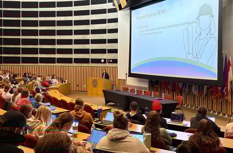 Holly Brenner speaking as emcee at the Women in Construction event at Marian University in Fond du Lac, Wisconsin