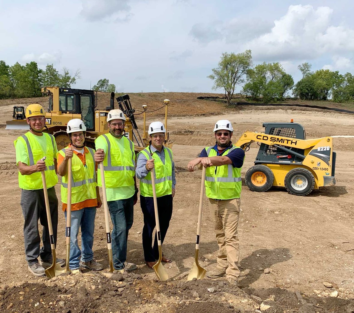 C.D. Smith Construction crew shoveling dirt at groundbreaking event at Waukesha Booster Pumping Station site