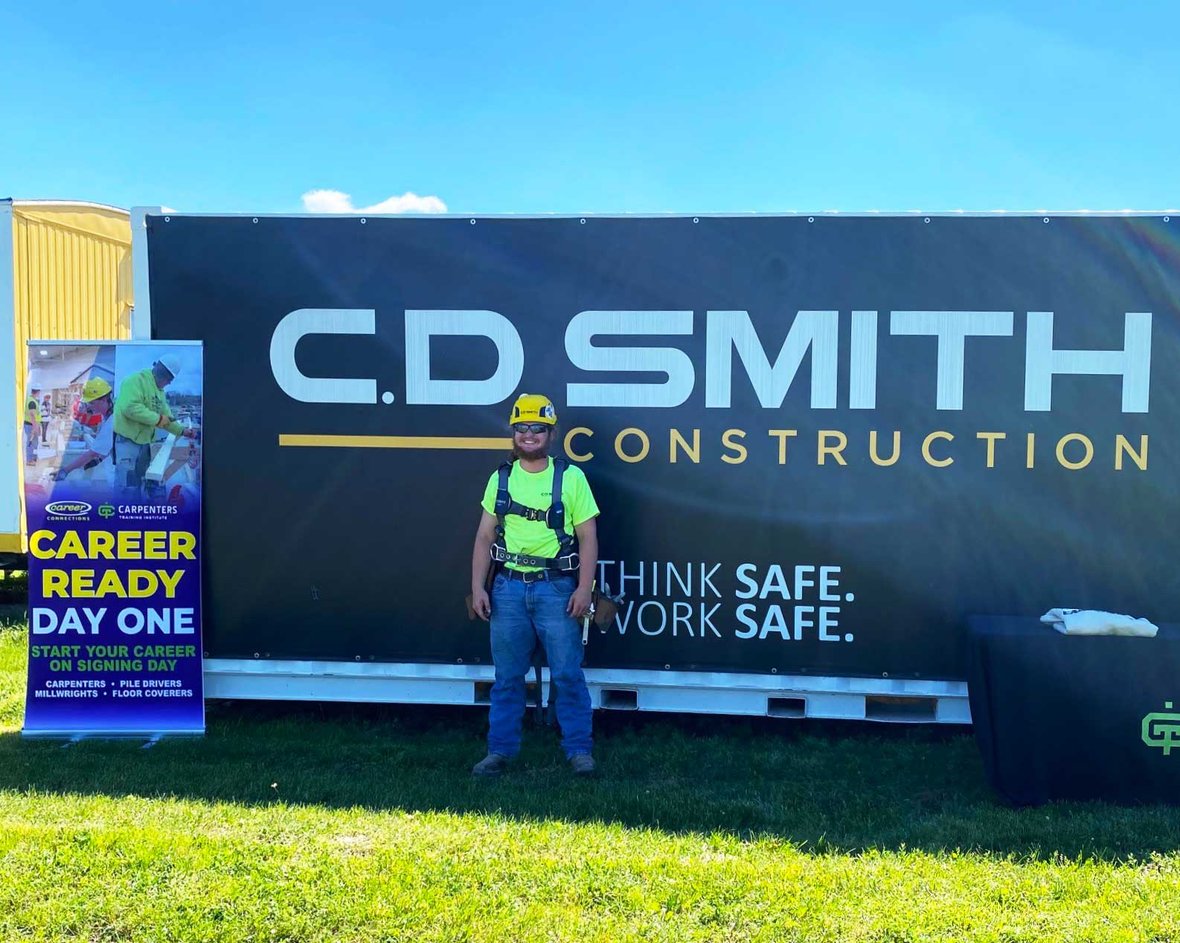 Signing day picture with Riley Zick being hired by C.D. Smith Construction while pursuing a carpentry apprenticeship