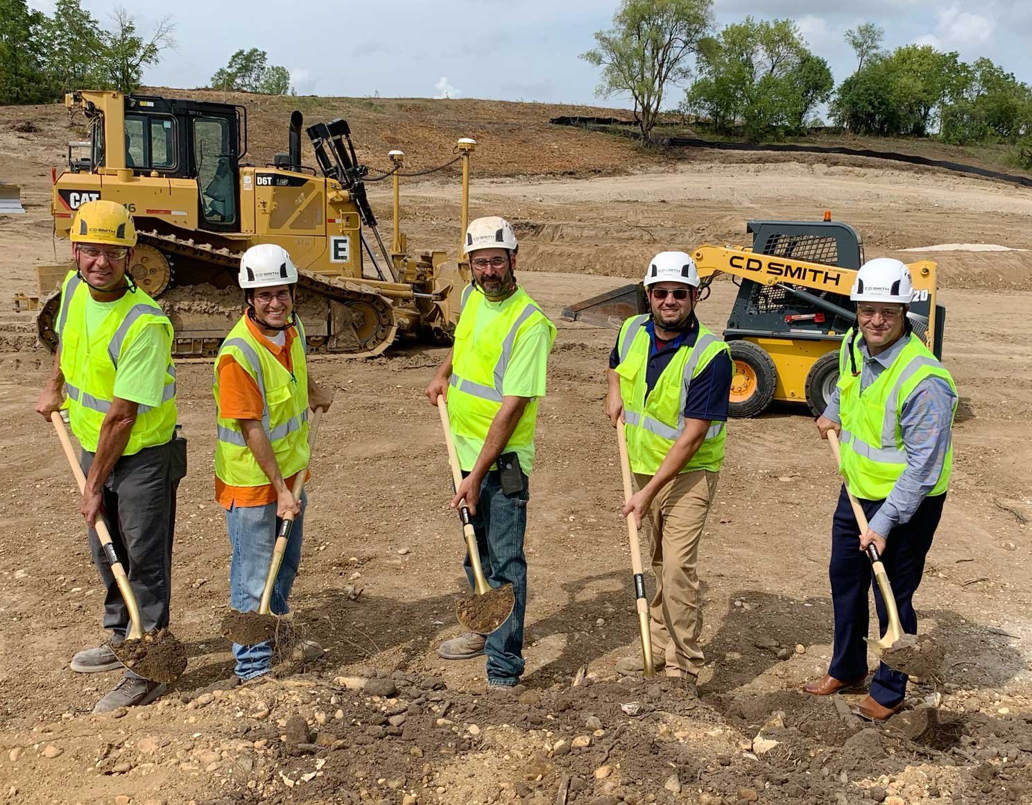 C.D. Smith Construction crew shoveling dirt at groundbreaking event at Waukesha Booster Pumping Station site