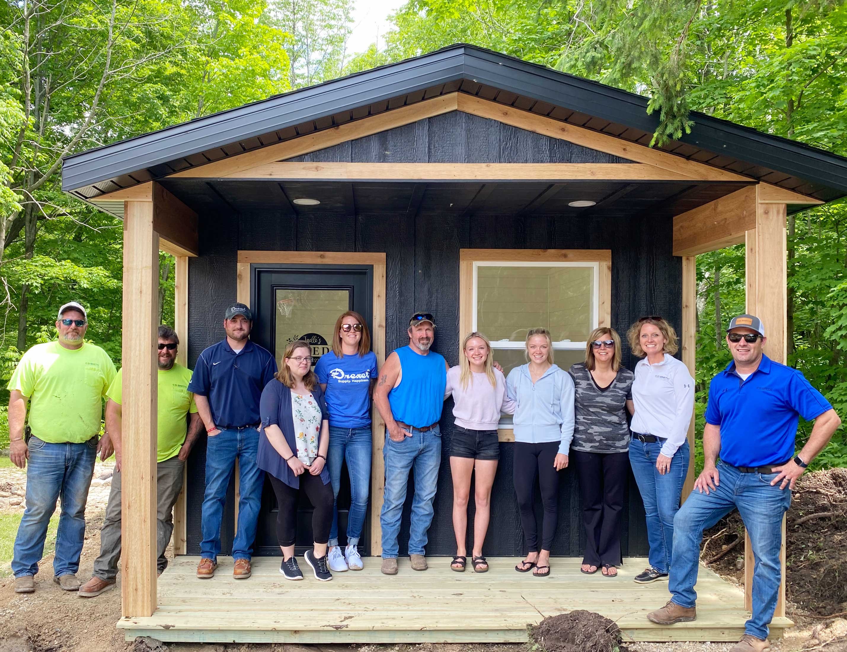 Make-A-Wish modern farmhouse She-Shed built by C.D. Smith Construction with the family standing in front.