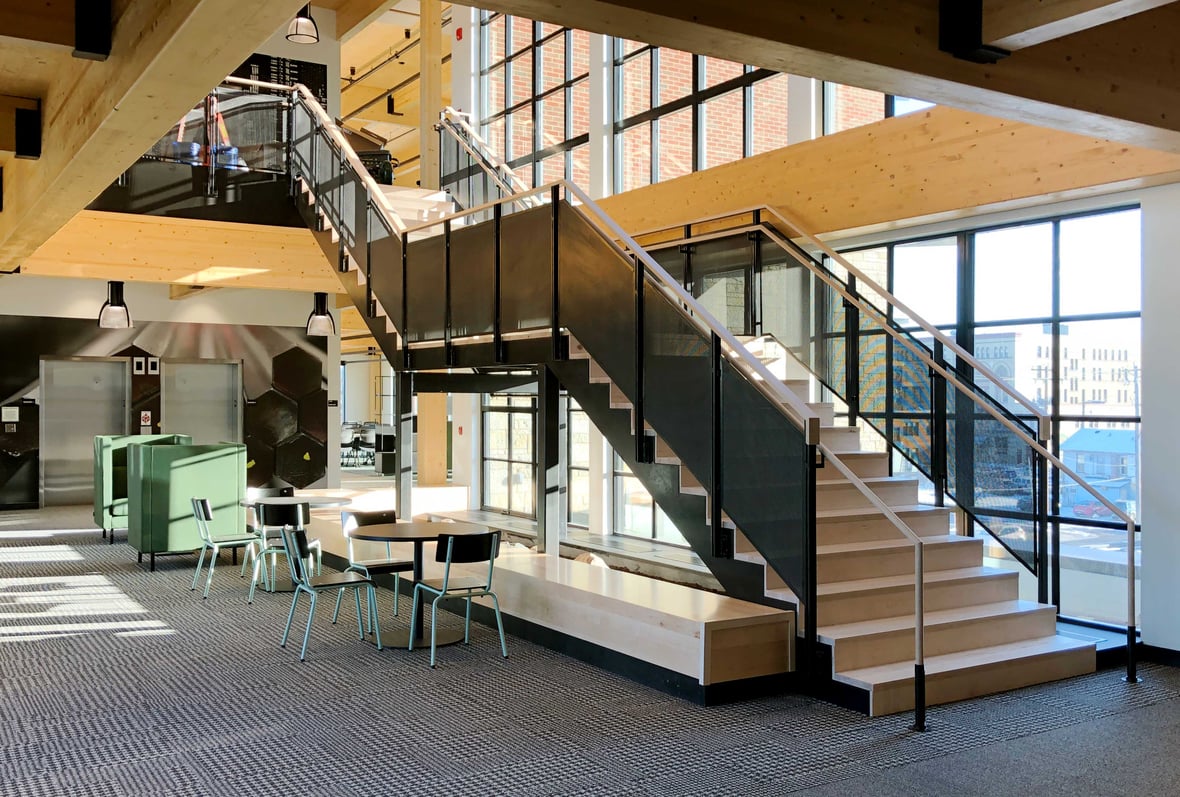 C.D. Smith Construction Manager for Fastenal Corporate Office Mass Timber Building Interior staircase with view of downtown Winona street