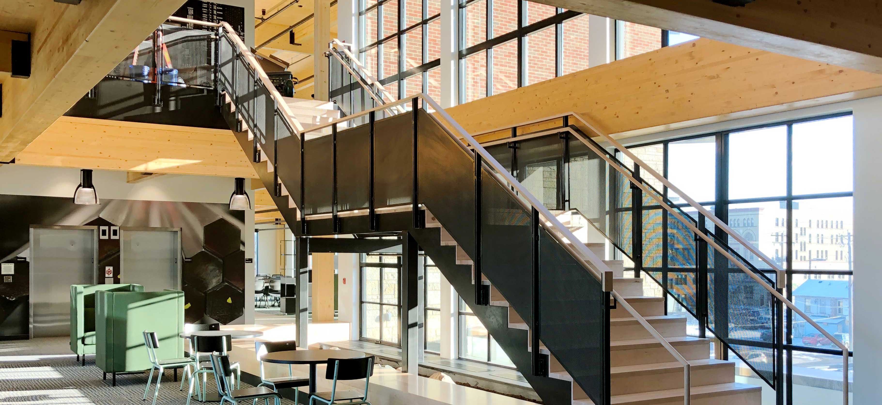 C.D. Smith Construction Manager for Fastenal Corporate Office Mass Timber Building Interior staircase with view of downtown Winona street