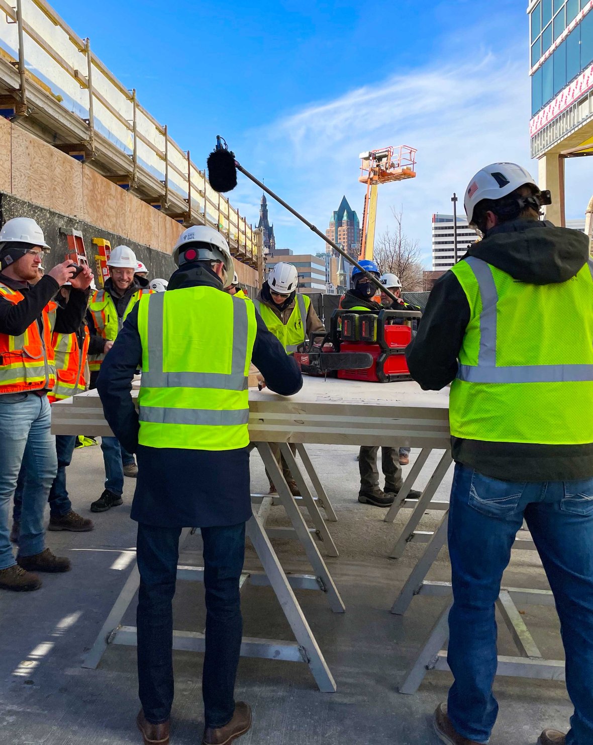 Tim(ber) Gokhman signing CLT for 25th floor to celebrate topping off Ascent mass timber tower as world's tallest with C.D. Smith Construction