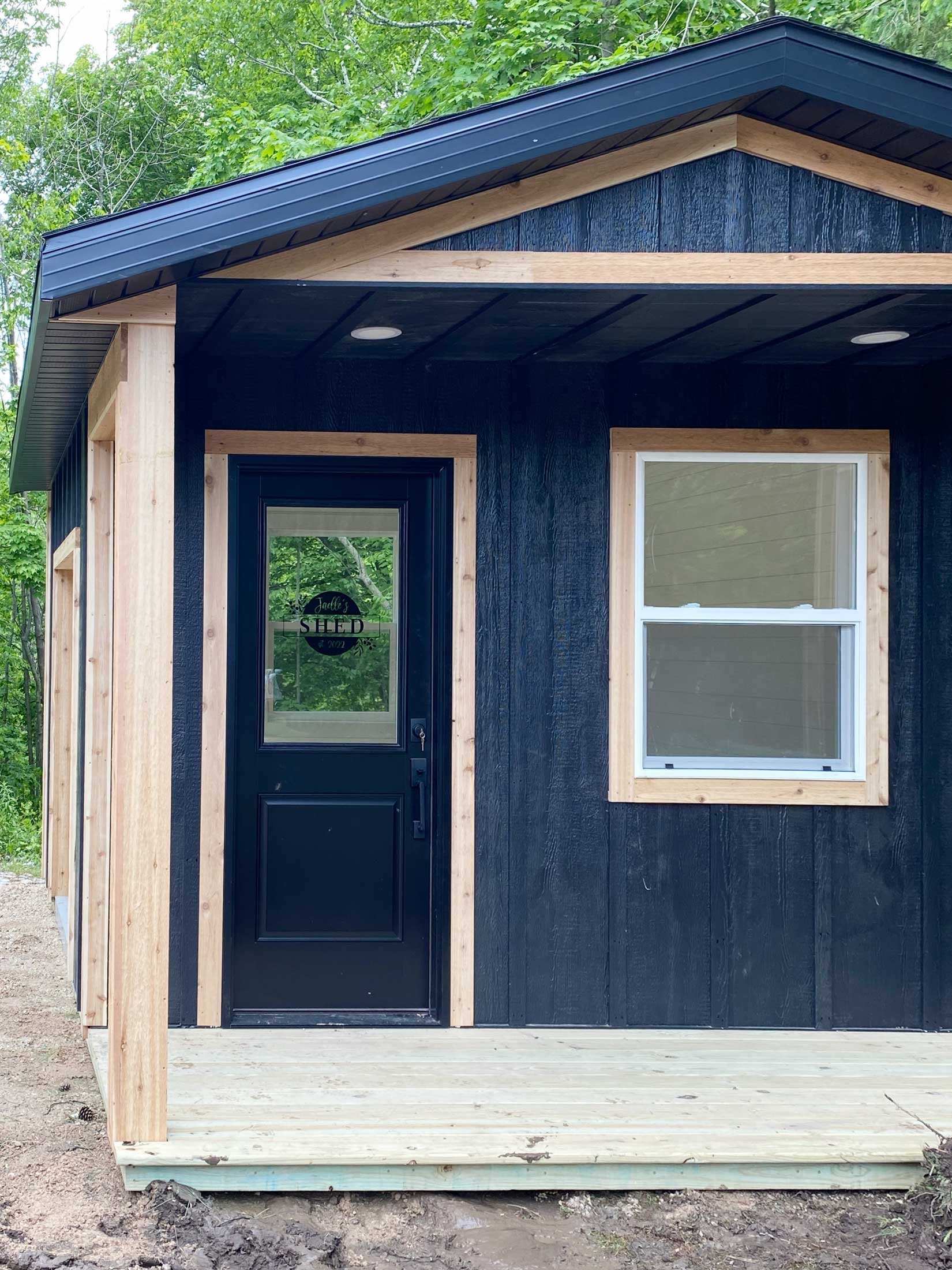 Make-A-Wish modern farmhouse She-Shed built by C.D. Smith Construction with Jaelle and family standing in front.