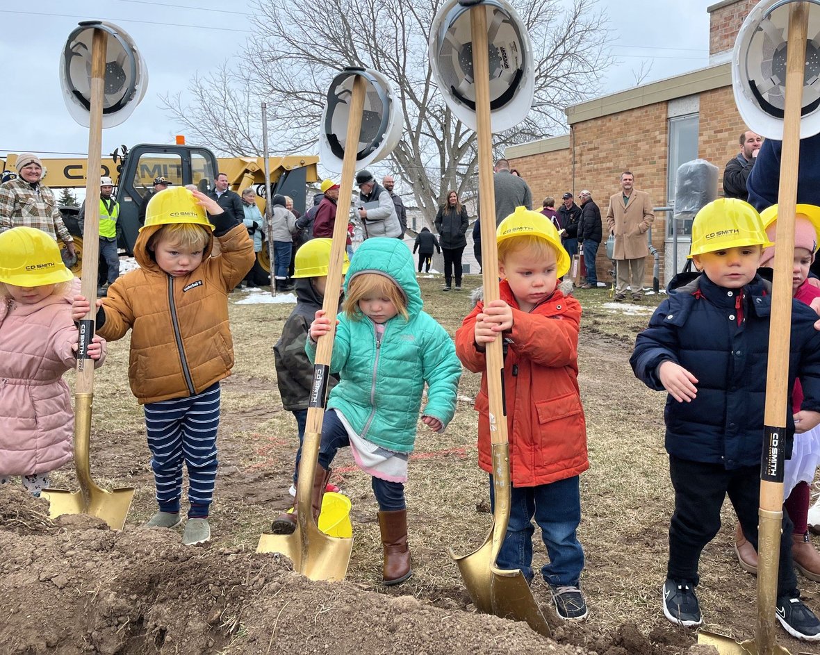 Little kids with shovels of dirt at St. Matthew School daycare project groundbreaking with CD Smith Construction