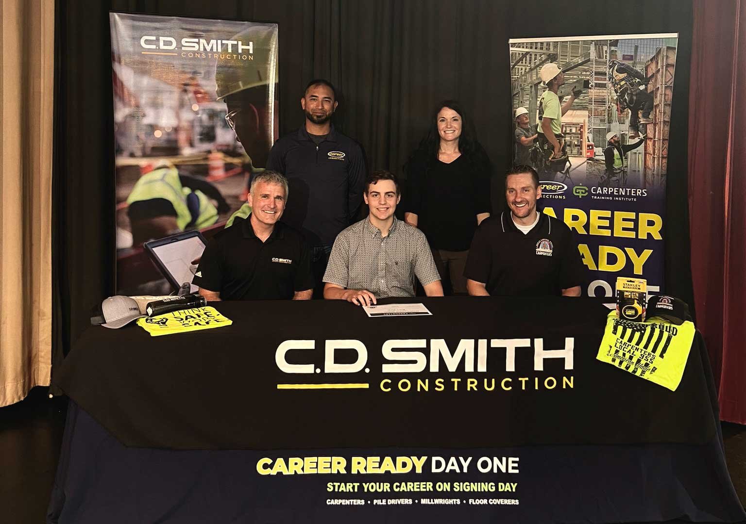 Signing day picture with Riley Zick being hired by C.D. Smith Construction while pursuing a carpentry apprenticeship