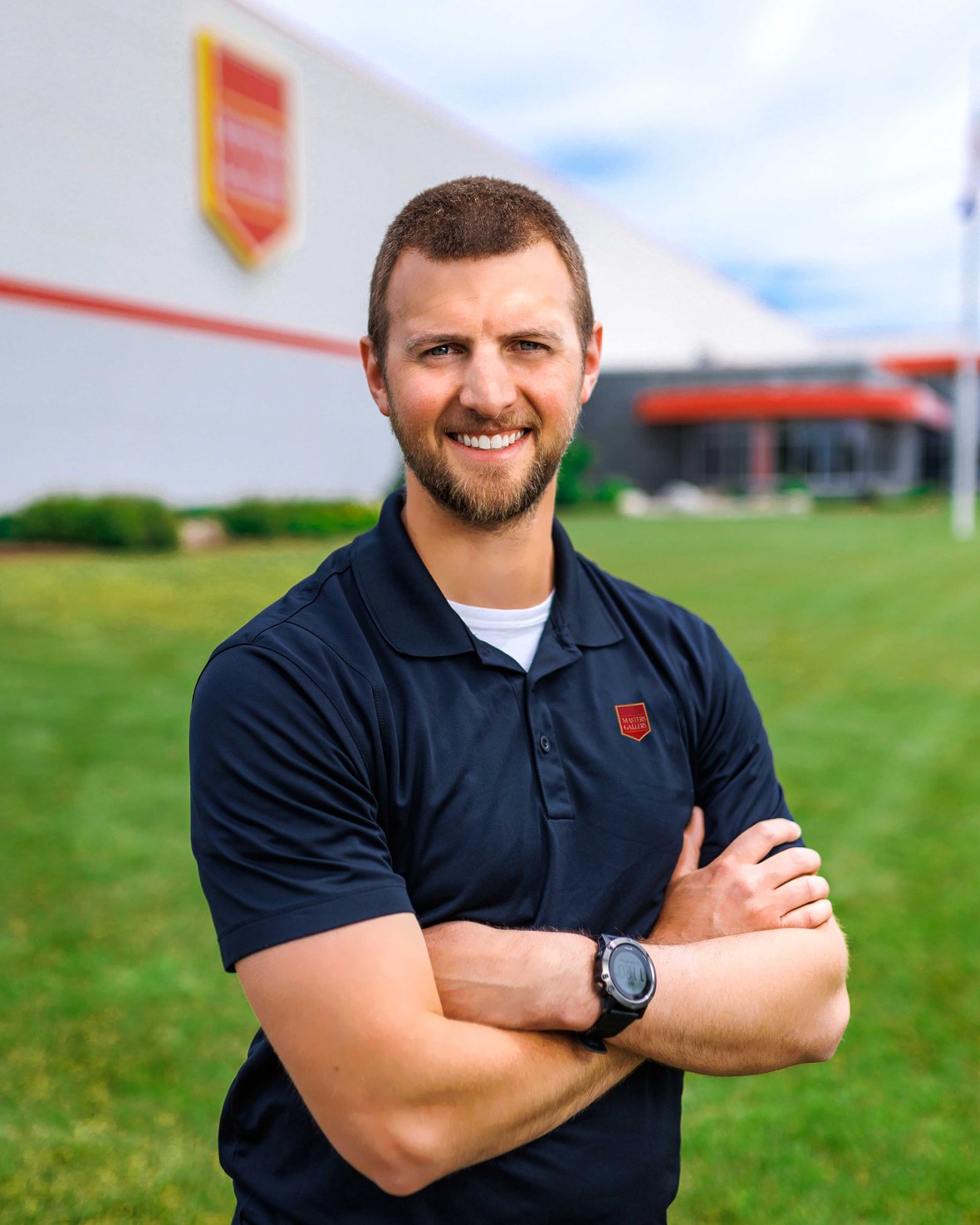 Scott Koenig, Engineering Program Manager at Masters Gallery Foods, standing in front of the facility built by C.D. Smith Construction
