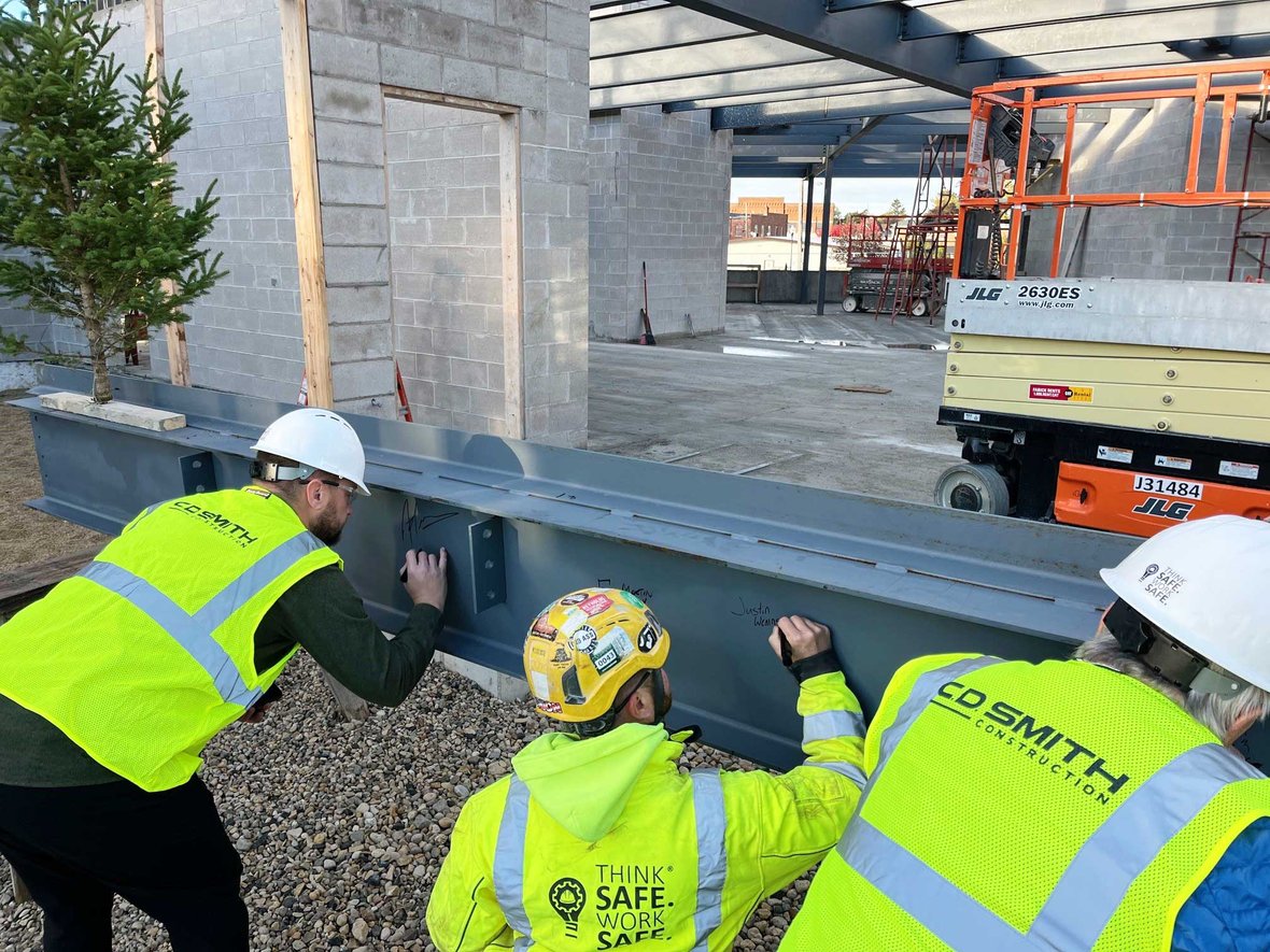 CD Smith Construction Crew & Project Team Stakedholders sign topping out beam for Kewaskum Community Center building in Wisconsin