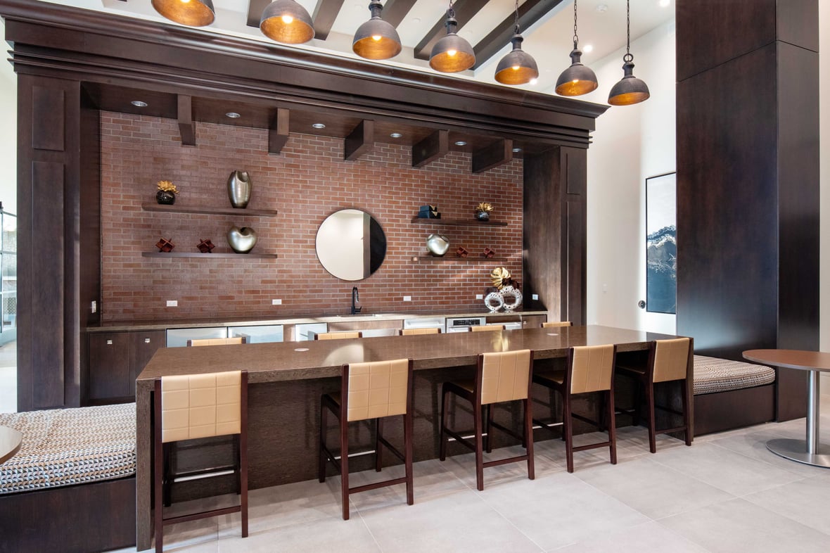Interior community kitchen island with brick backsplash at Brickline at The Mercantile apartment building in Omaha Nebraska with CD Smith Construction Manager