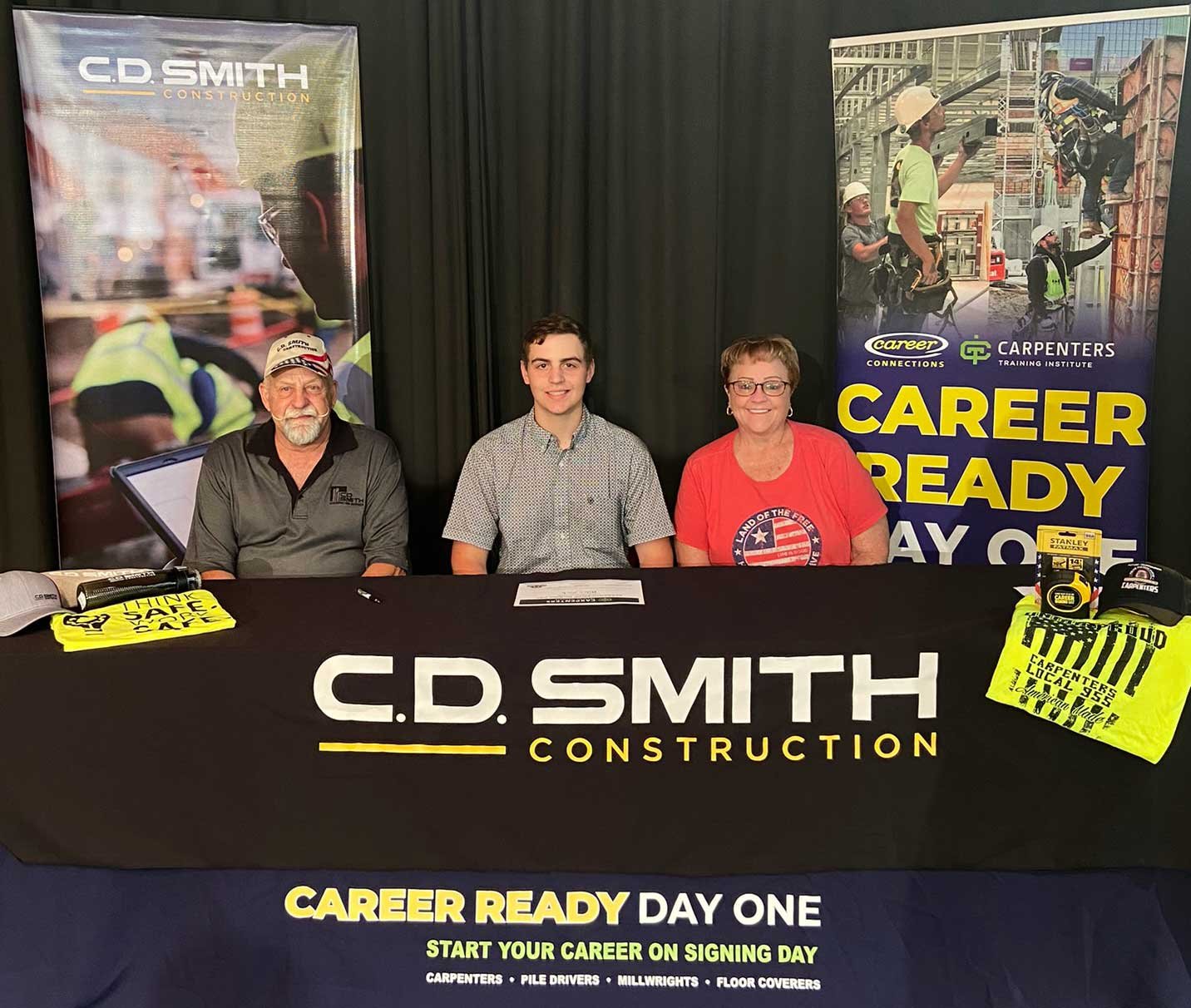 Signing day picture with Riley Zick being hired by C.D. Smith Construction while pursuing a carpentry apprenticeship