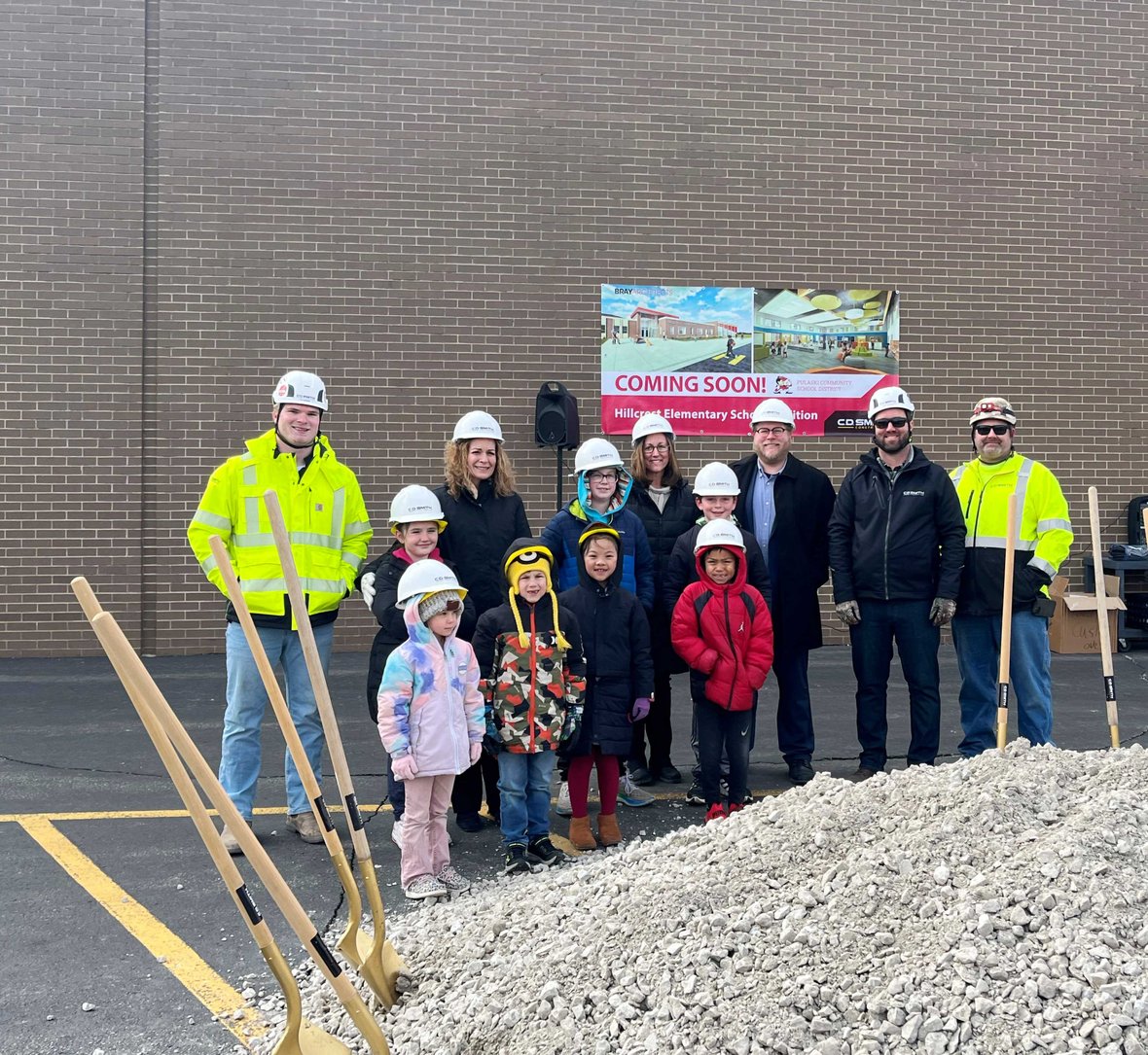 Superintendent students and project team with shovels and CD Smith Construction hard hats at Pulaski Hillcrest Elementary School Project Groundbreaking