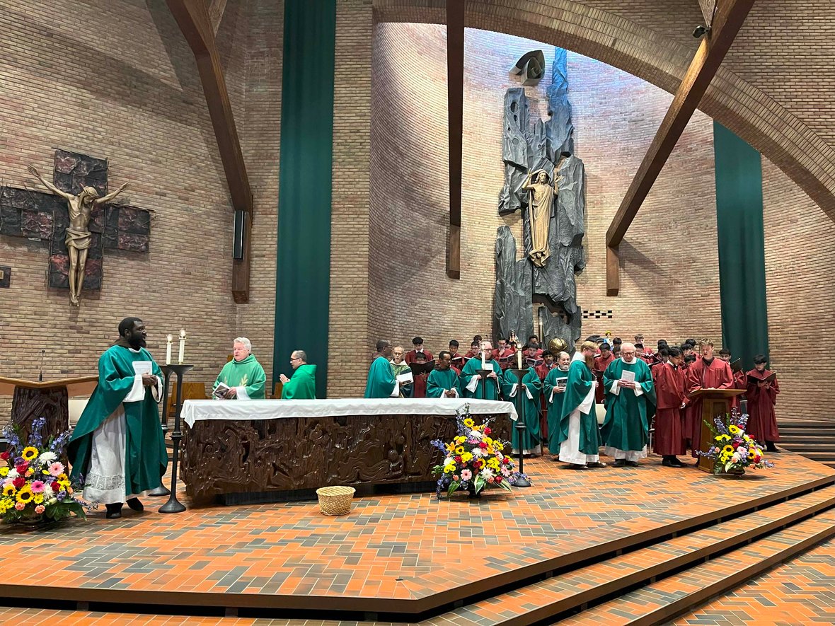 Priests, choir, and students leading Mass in the chapel at St. Lawrence Seminary during the dedication of Fr. Solanus Hall.