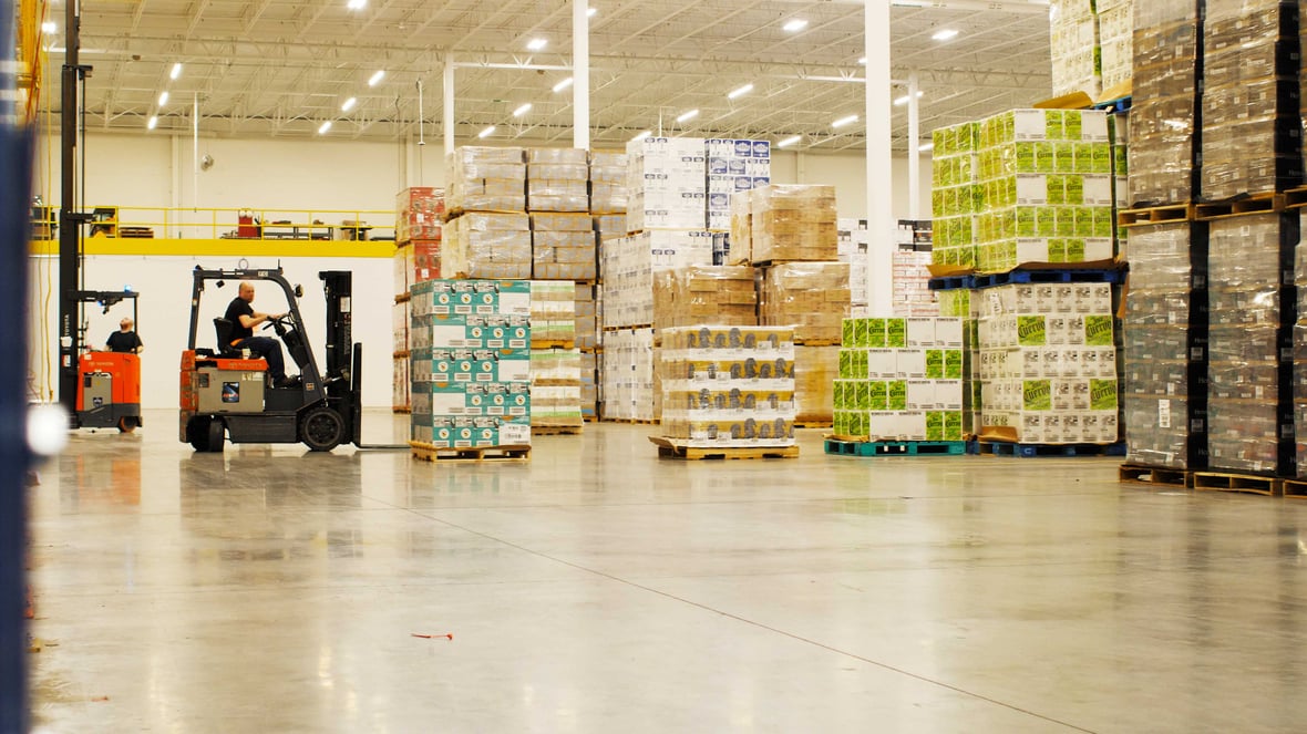 Forklift drivers in Badger Liquor warehouse built by C.D. Smith Construction prepping for distribution