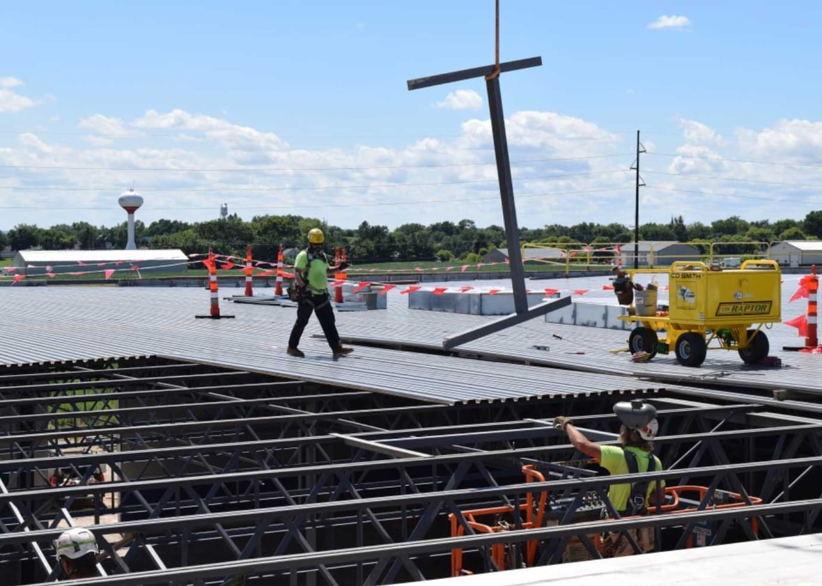C.D. Smith Construction workers on the roof of Kondex addition for steel installation