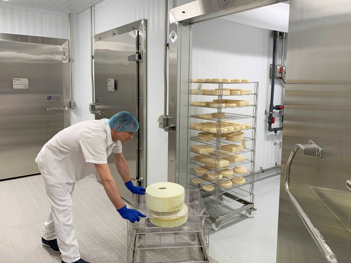 Man wheeling cheese into ripening room at Center for Dairy Research CDR UW-Madison Babcock Hall