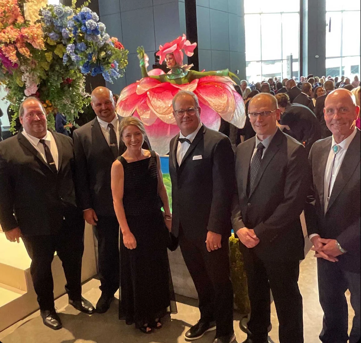 CD Smith Construction Team with dancer in the background at Baird Center Expansion Project Grand Opening Gala in Milwaukee Wisconsin