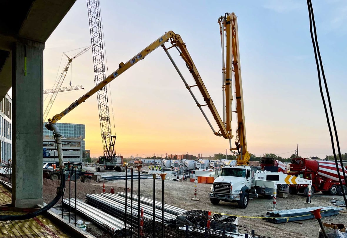 Concrete pump truck positioned at the Forensic Science and Protective Medicine Facility jobsite, showing large-scale equipment used in Wisconsin public health facility construction.