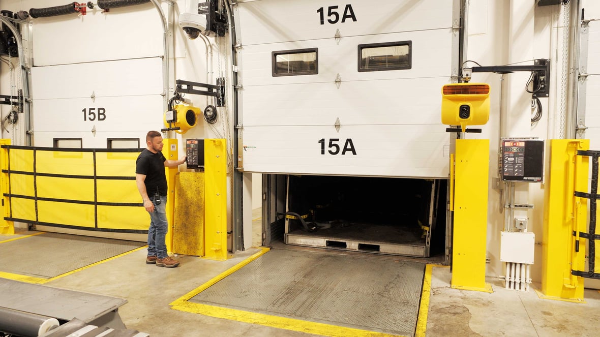 Badger Liquor worker opening door of loading dock at warehouse built by C.D. Smith Construction