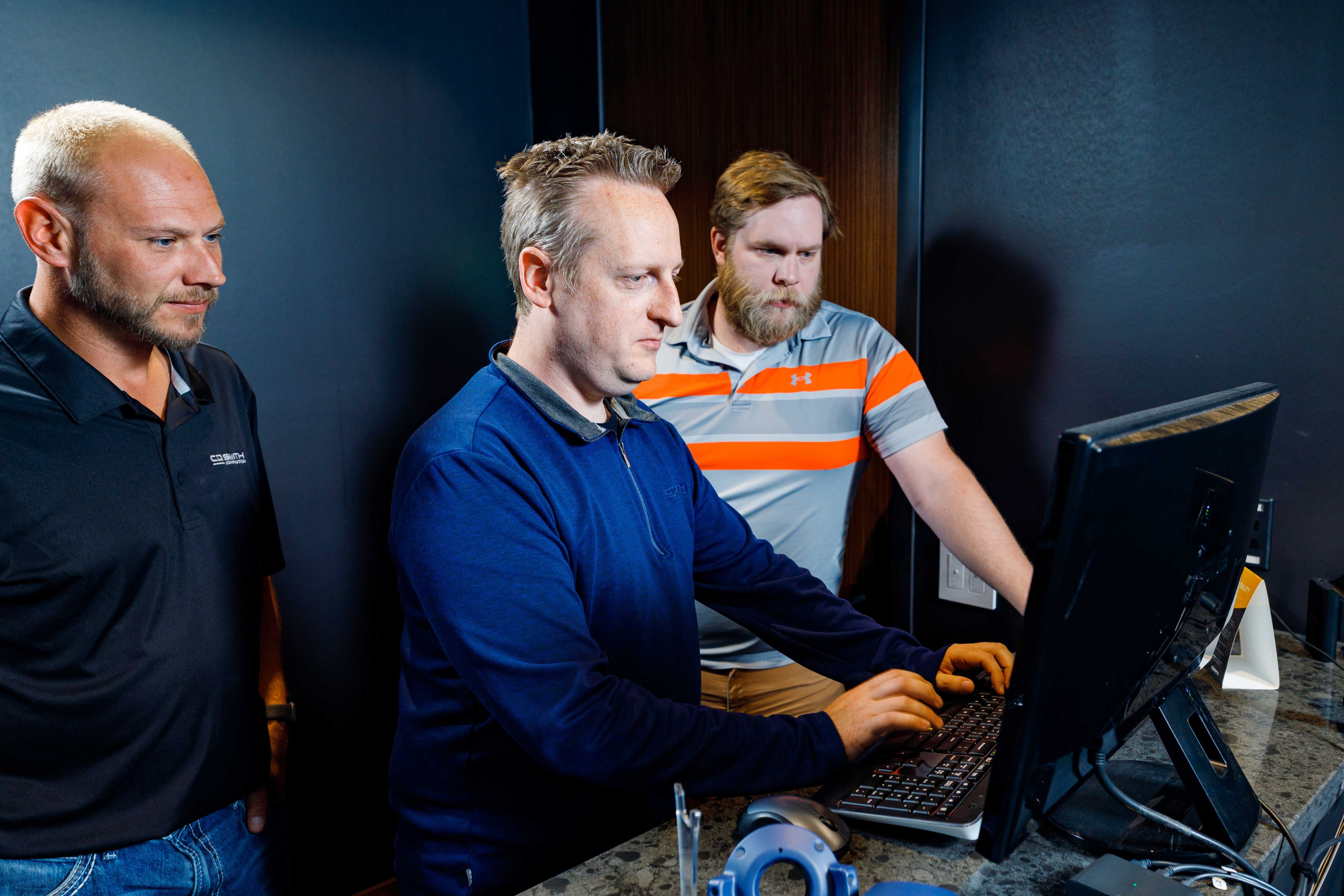 CD Smith Virtual Design + Construction team at desktop monitor navigating virtual project site in collaboration on project in Wisconsin