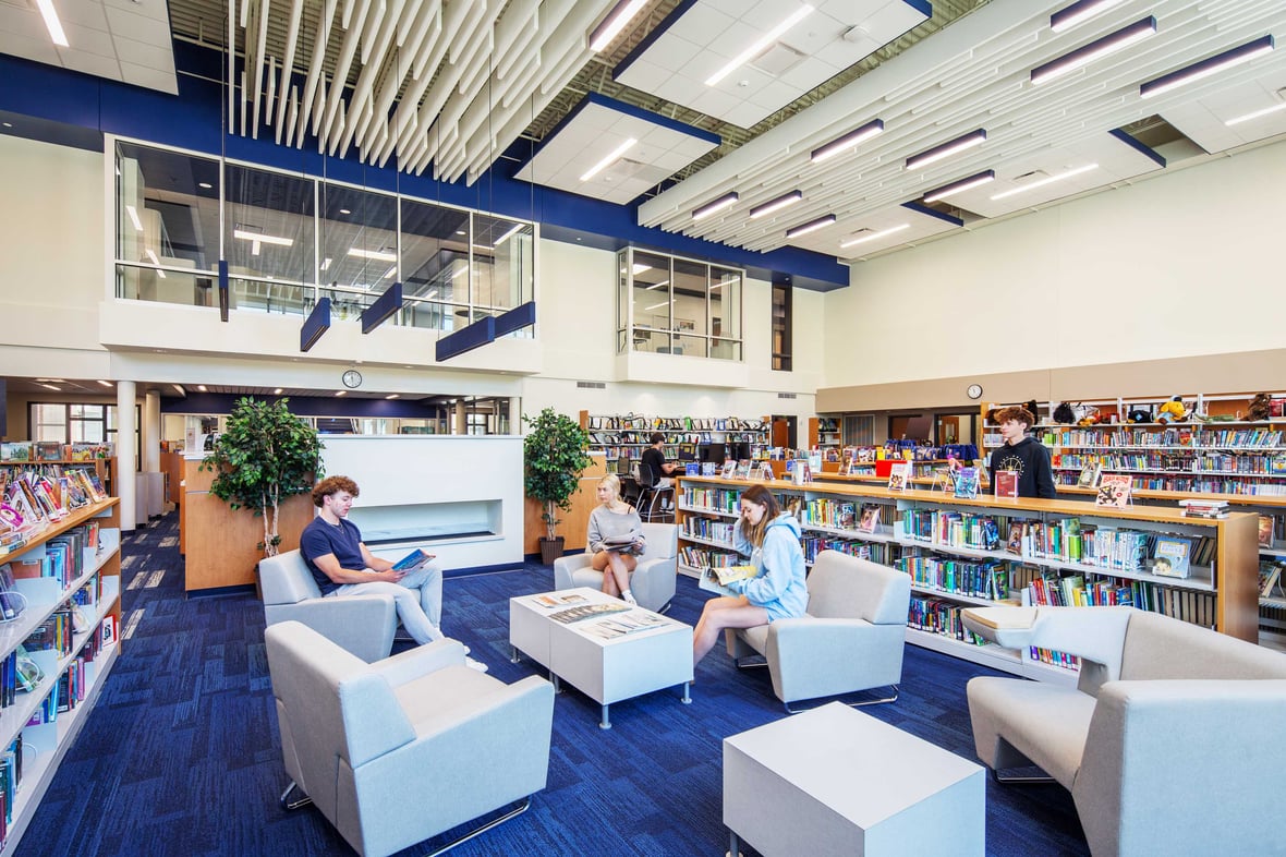 Students comfortably reading and collaborating in the common areas of the Kohler School District library, illustrating a vibrant atmosphere that fosters learning and community interaction.