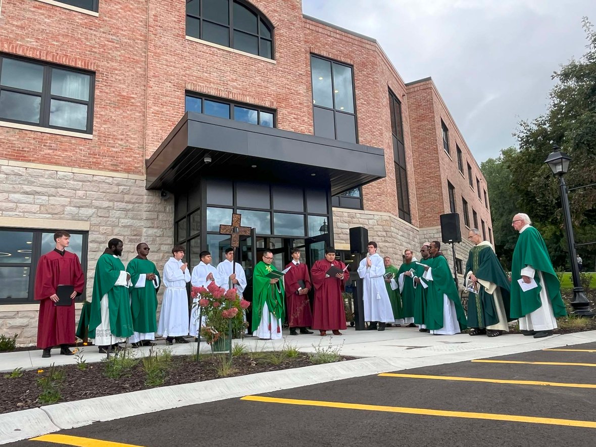 Clergy, students, and guests gathered outside Fr. Solanus Hall for the dedication ceremony.