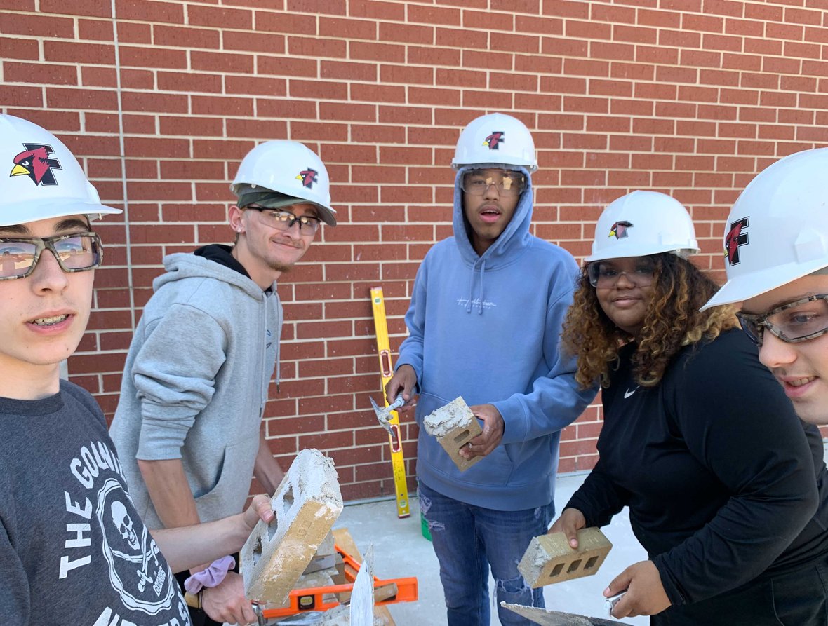 Fond du Lac Architecture Construction Engineering students working in a masonry construction practice are laying bricks