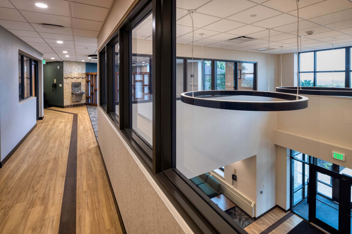 Corridor and overlook inside Fr. Solanus Hall showing modern lighting, windows, and common areas.