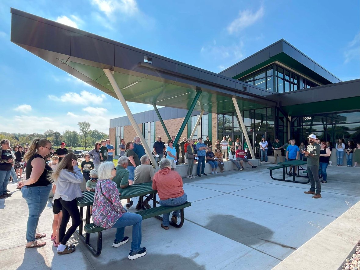 Families, students and community members gather under the new Laconia school entrance canopy during the ribbon cutting ceremony.