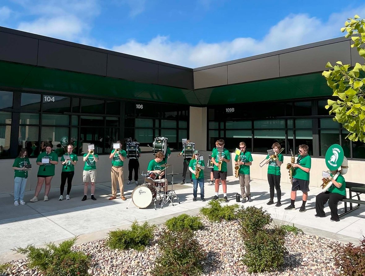 The Laconia High School pep band performs outside during the Rosendale-Brandon ribbon-cutting ceremony.
