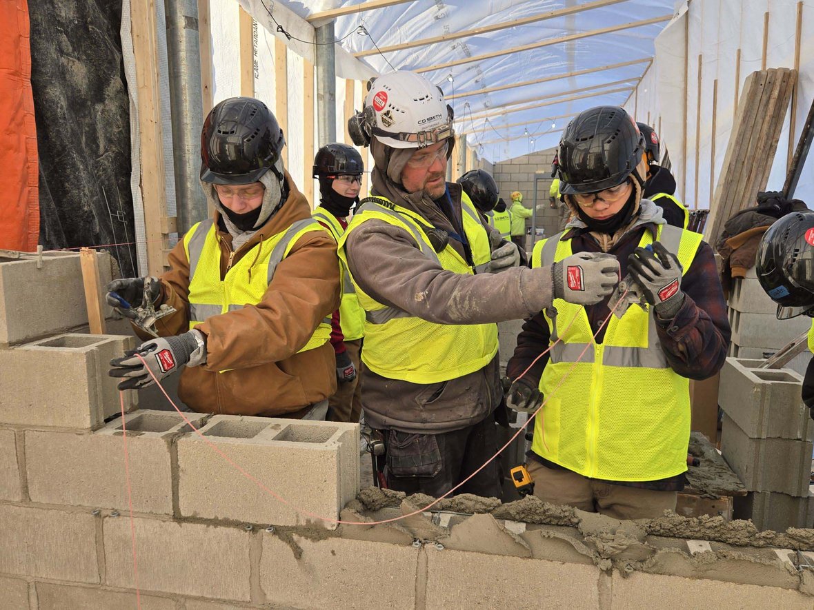 Franklin High School students receiving hands-on masonry instruction from a C.D. Smith construction professional as part of the CDS School Partnership Program skilled trades education initiative.