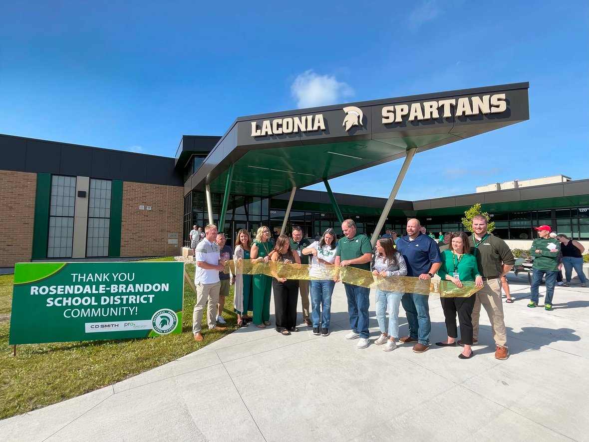 Rosendale-Brandon School District leaders, students and community members cut the ribbon in front of Laconia High School during the referendum celebration.