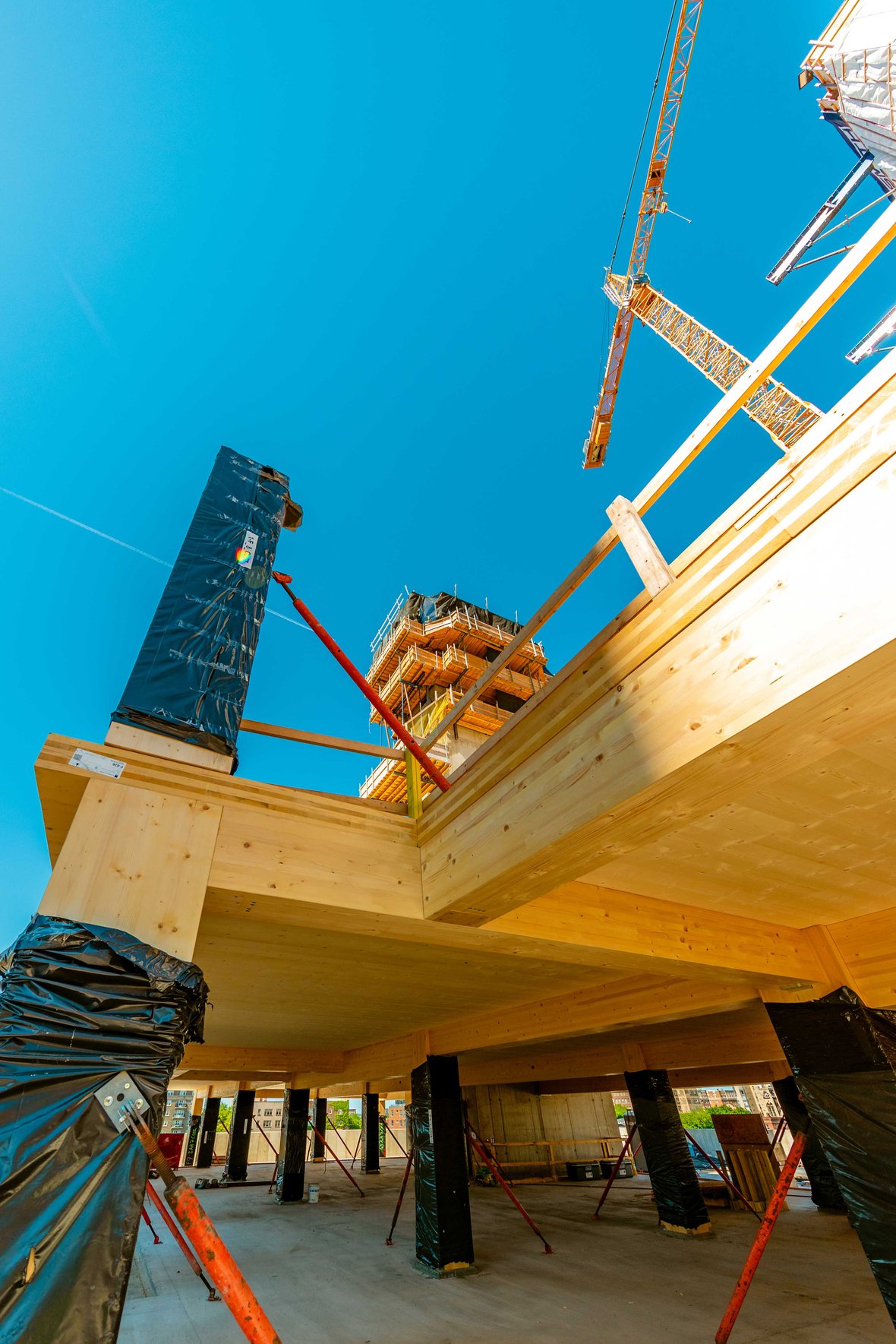 Mass timber construction progress in June 2021 showing CLT and glulam beams, columns and decking