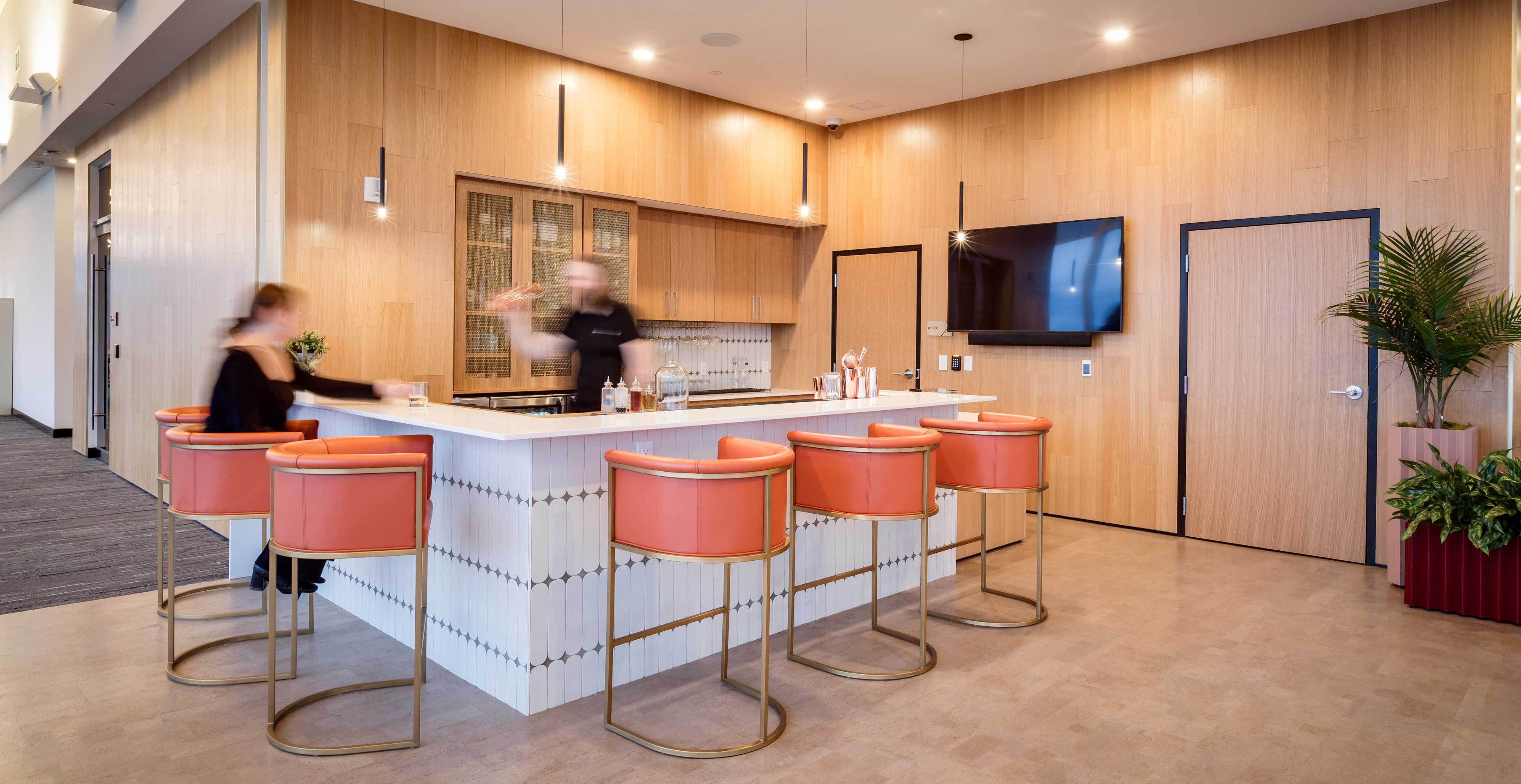 25th floor amenity bar at Ascent Milwaukee featuring exposed mass timber walls, custom millwork, and contemporary lounge seating.