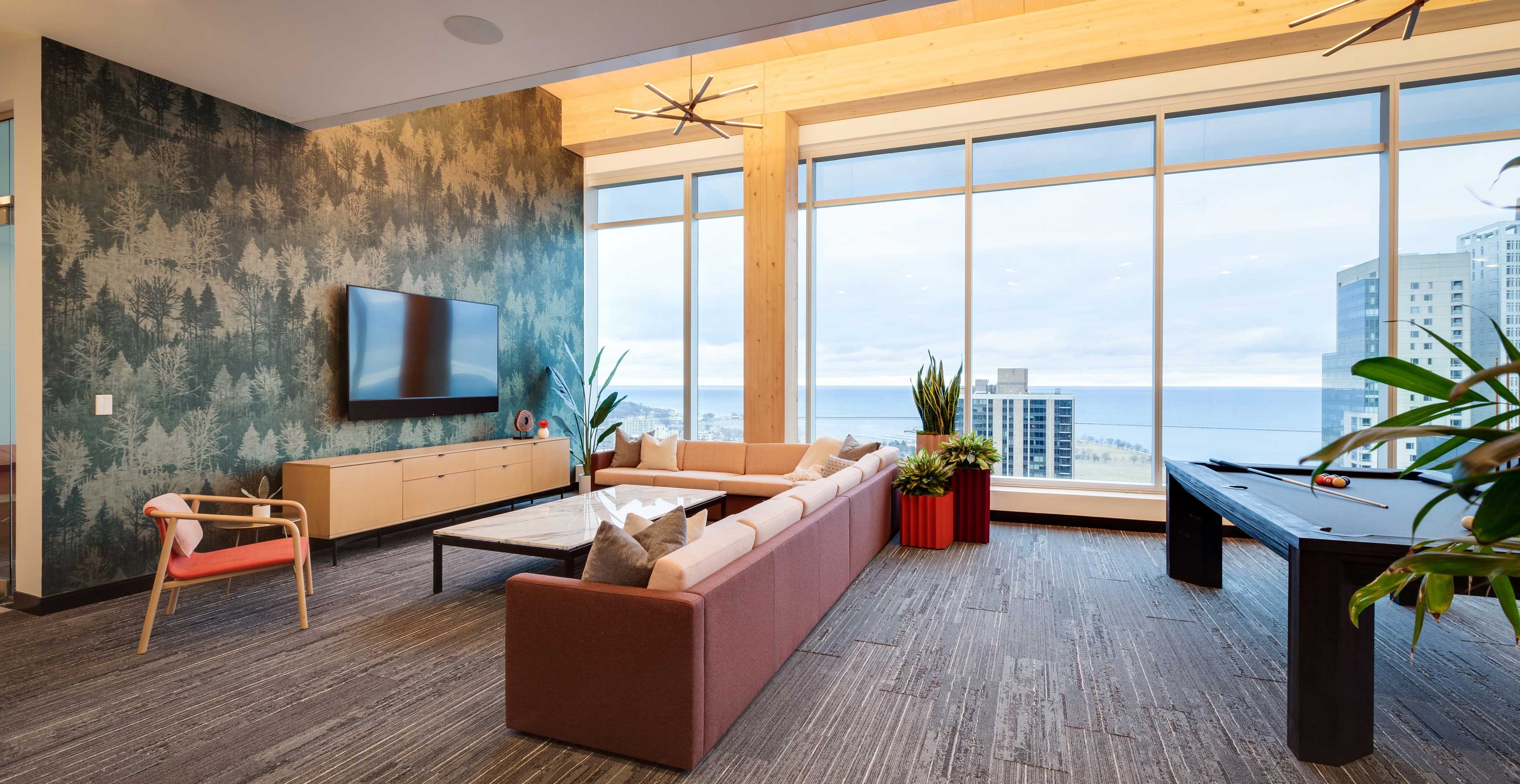 Recreation area at Ascent Milwaukee with exposed structural timber, expansive glazing, and elevated city views.