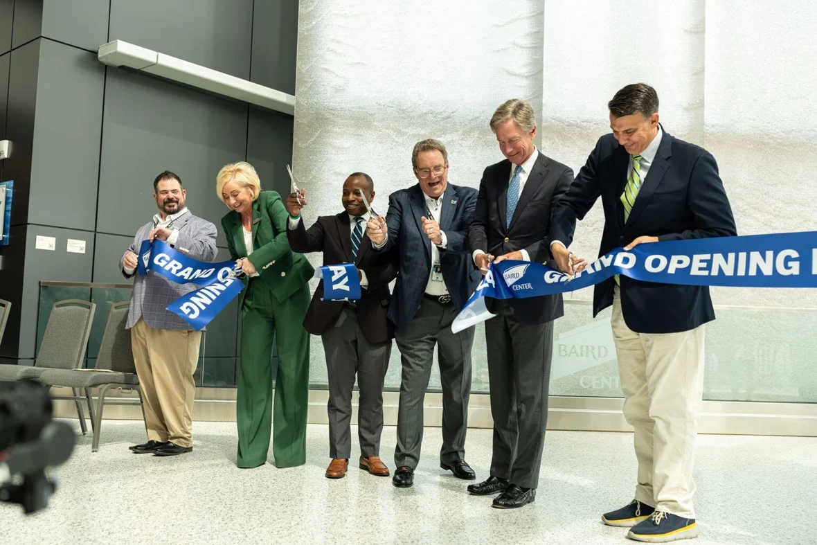 Baird Center Expansion Project action shot of Wisconsin Center District and project stakeholders cutting the grand opening ribbon