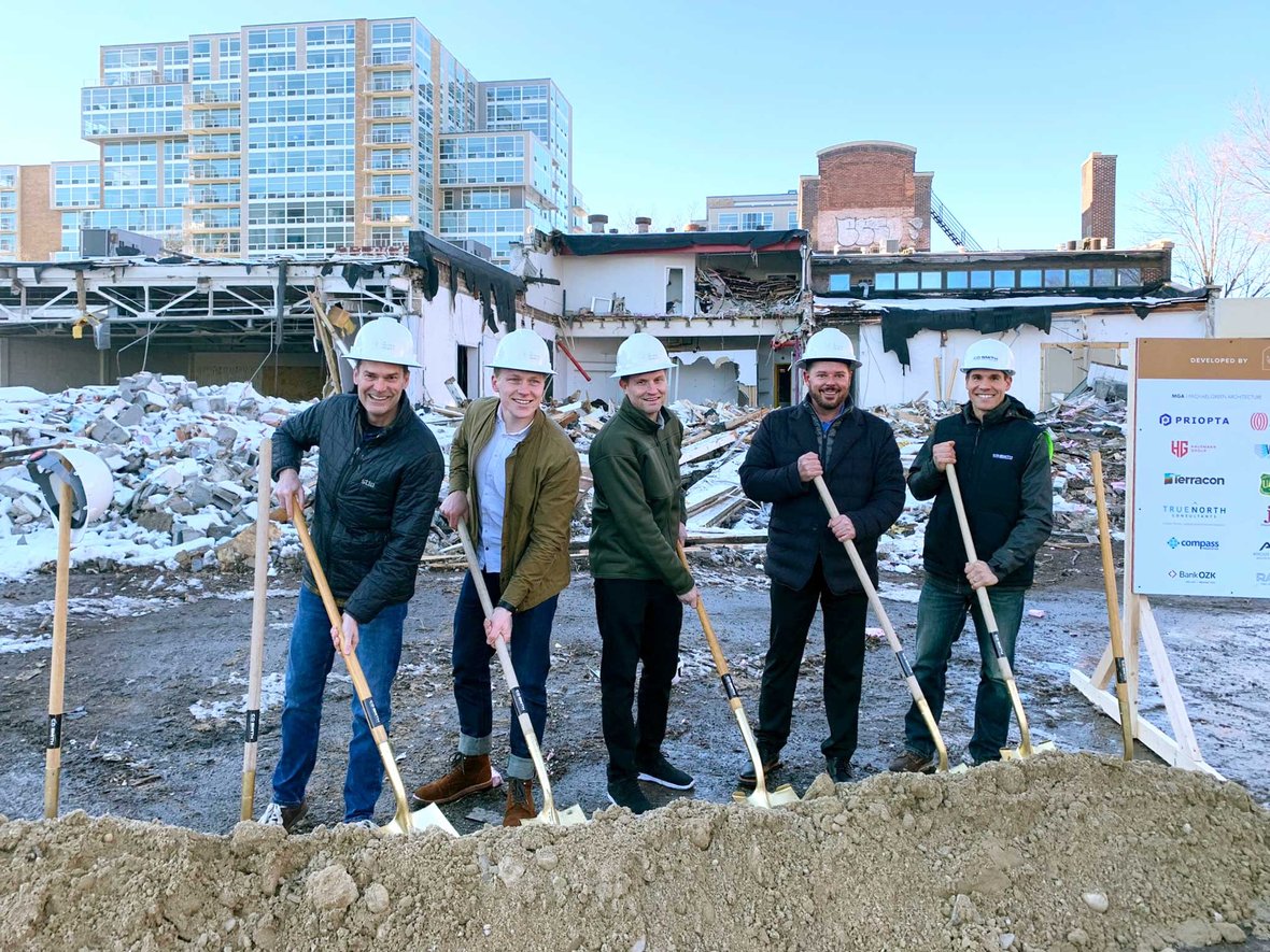 Five groundbreaking participants hold shovels at groundbreaking for Bakers Place mass timber construction project in Madison, Wisconsin