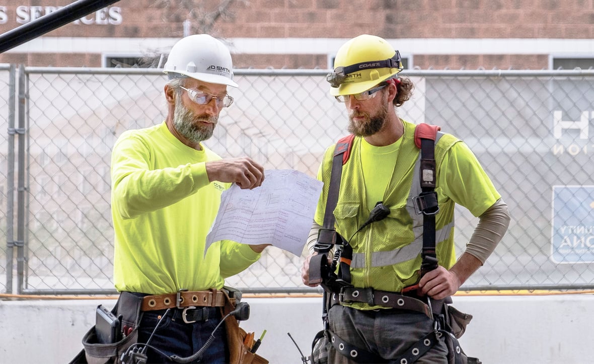 C.D. Smith Construction Superintendent Wayne Holum working with a team member in the field on a commercial project jobsite