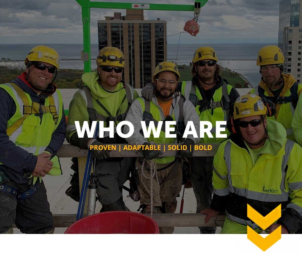 CD Smith Construction carpentry building crew on top of Ascent mass timber project in Milwaukee Wisconsin with WHO WE ARE text overlay