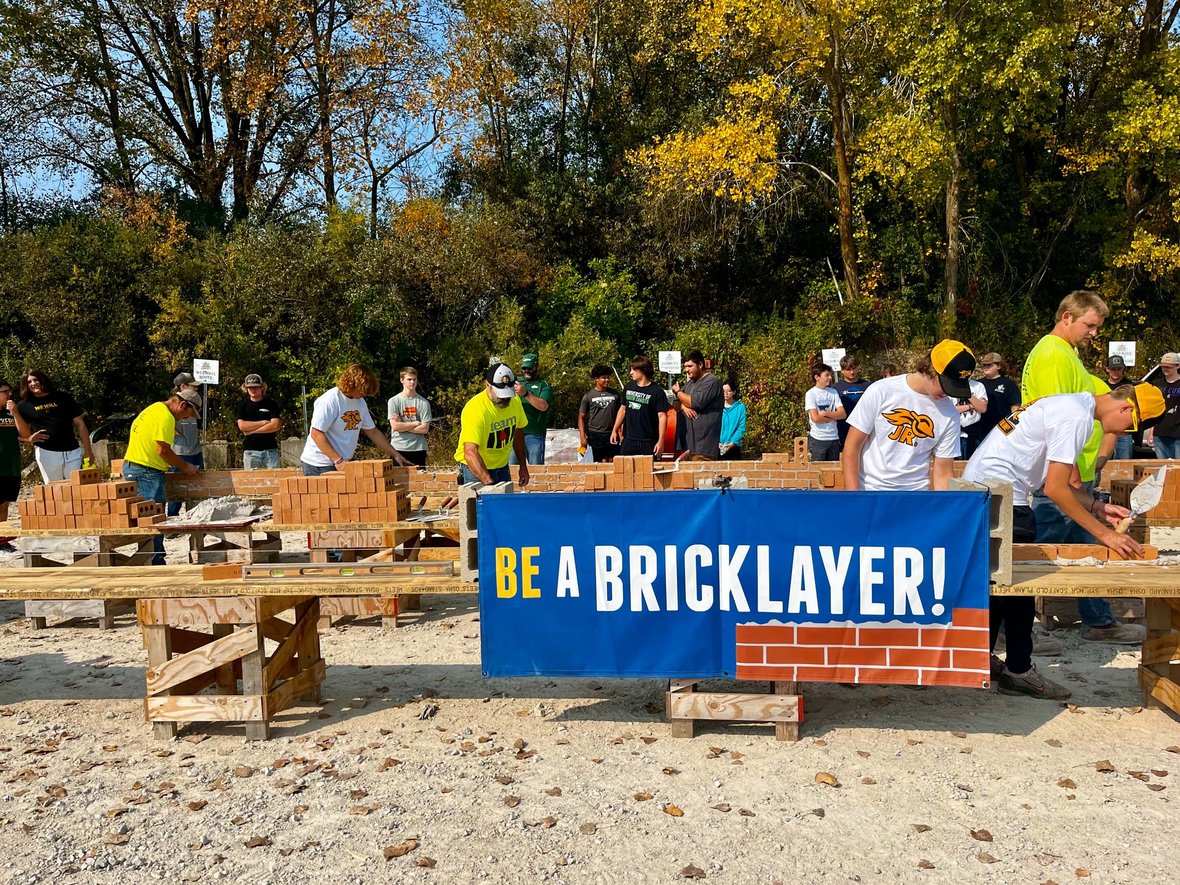 CD Smith Construction tradespeople teaching brick masonry in practice area 20240911_154948771_iOS