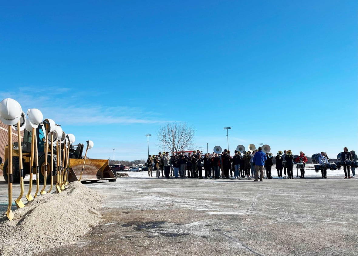 CD Smith Construction hard hat helmets on shovels at Pulaski High School Tech Ed Project Addition Groundbreaking with band performing in the background