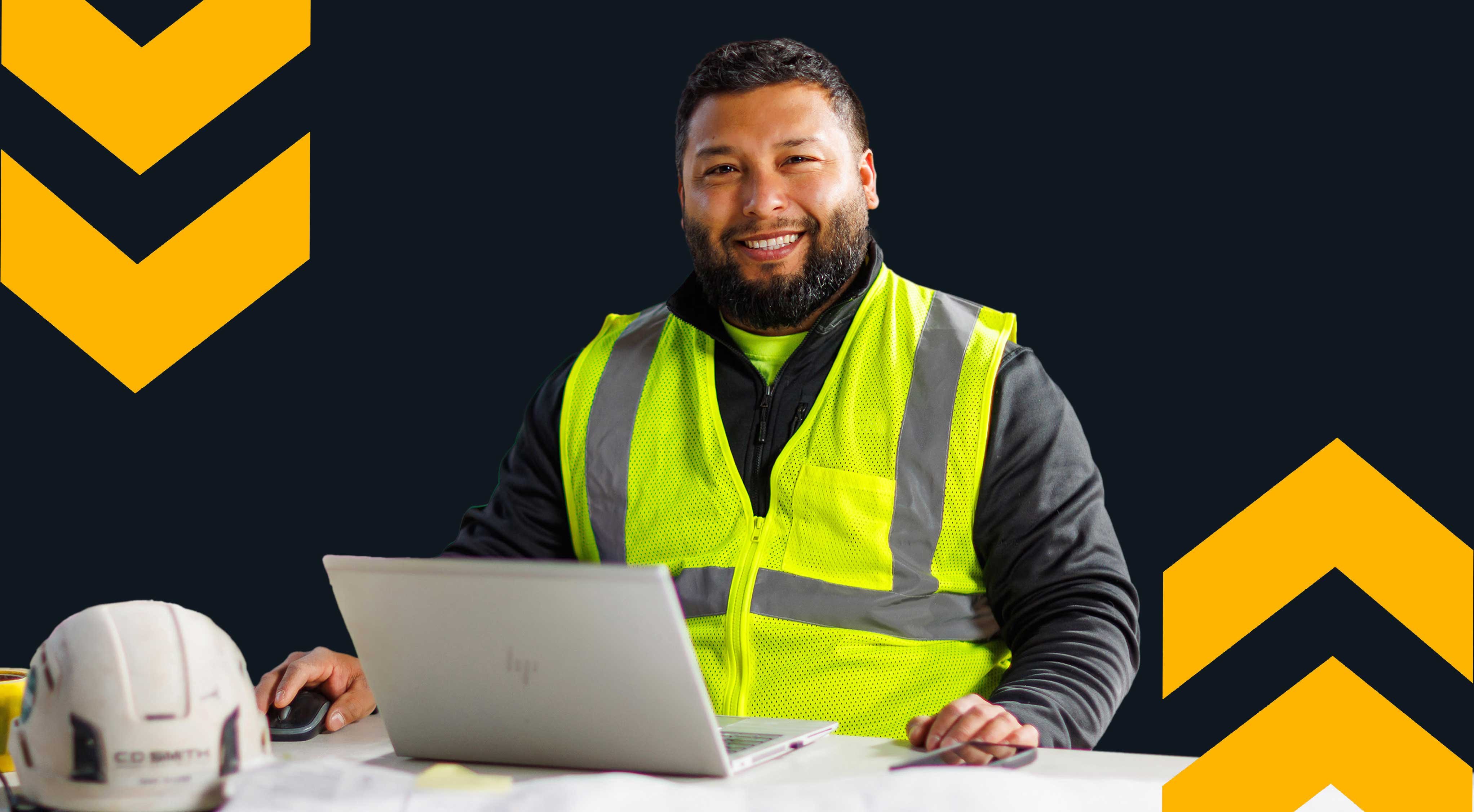 CD Smith Superintendent Isaac Guzman in project jobsite trailer on laptop