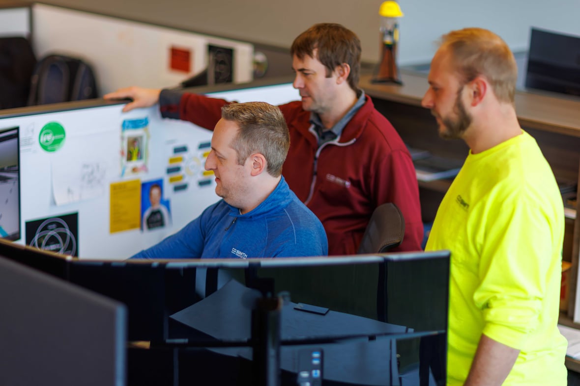 CD Smith Virtual Design & Construction VDC Team three people looking at virtual design on monitor at FDL Wisconsin Office