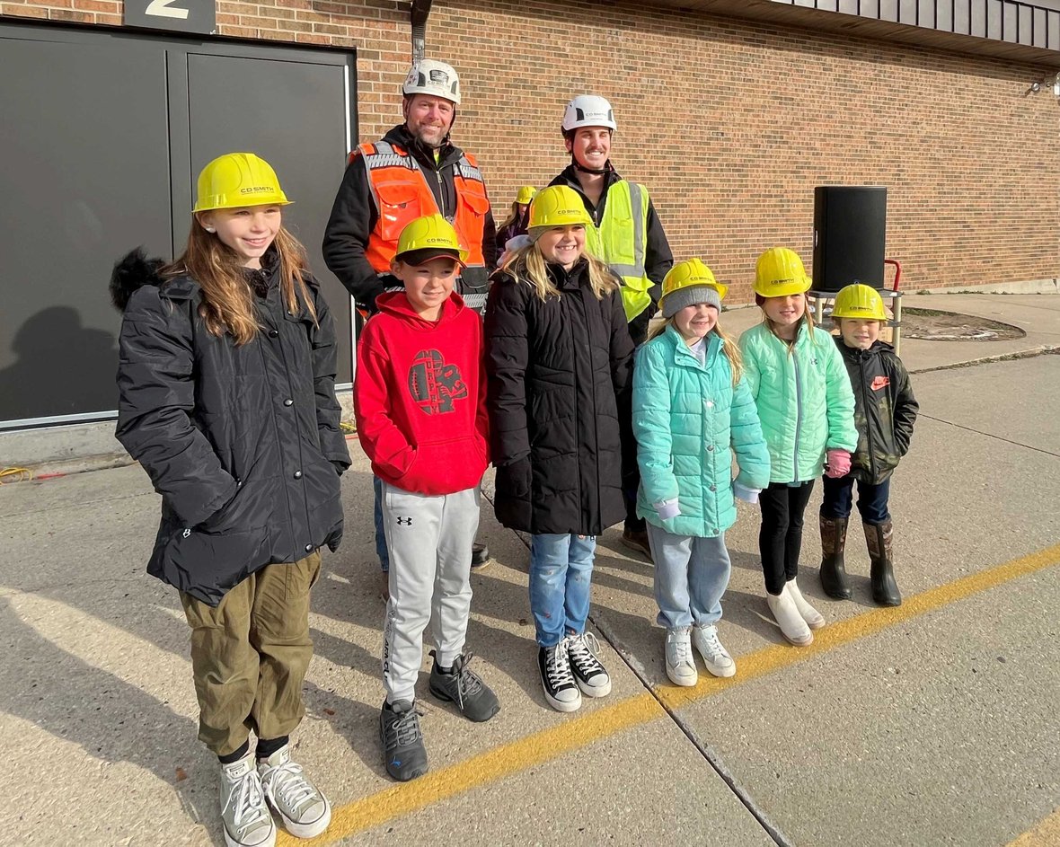 CD Smith Construction team poses with students at Pulaski School District Sunnyside Project Groundbreaking