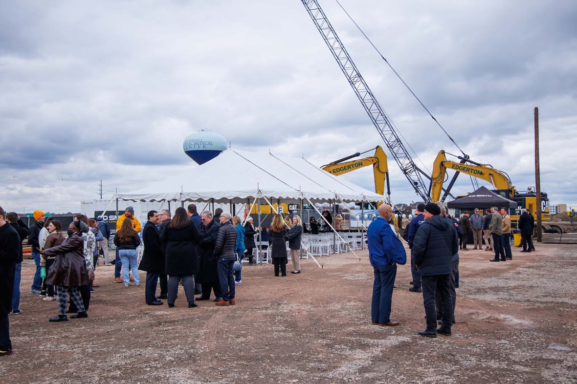 Crowd gathering at building site before groundbreaking ceremony for the Forensic Science and Protective Medicine Facility project construction with CD Smith