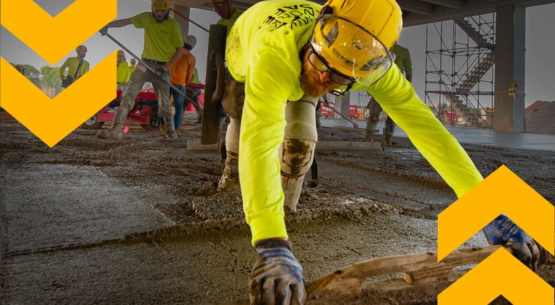 Concrete-worker-in-high-visibility-PPE-at-a-construction-site,-representing-CD-Smith-expertise-in-building-solutions