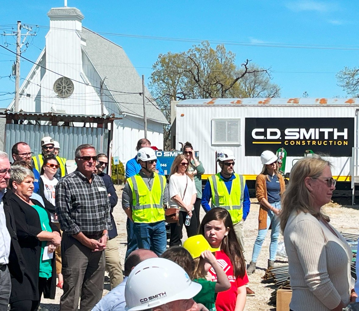 Crowd listening to Speaker at podium for Boys & Girls Club of the Tri County Area at groundbreaking for Ripon facility with CD Smith Construction trailer in background