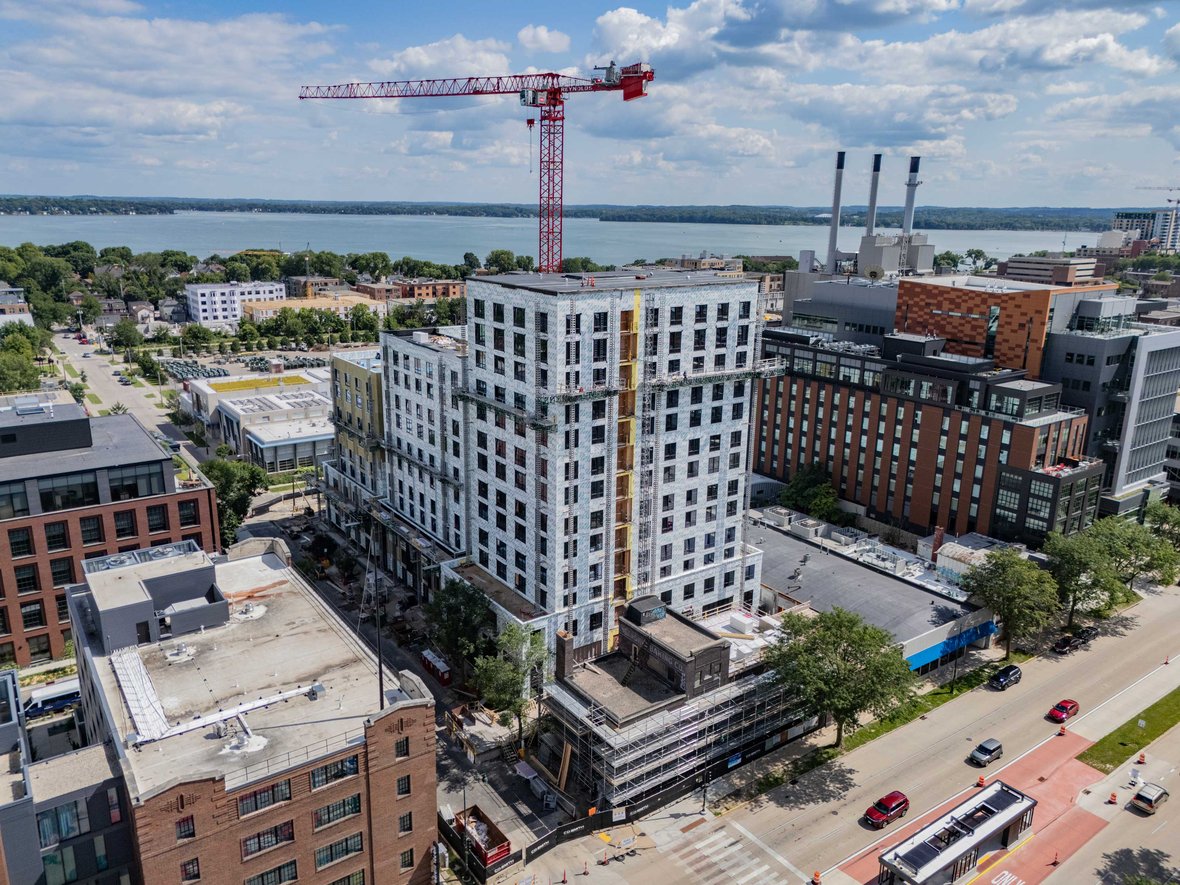 Drone photo of crane working on Bakers Place Mass Timber Construction project in Madison Wisconsin with CD Smith Construction